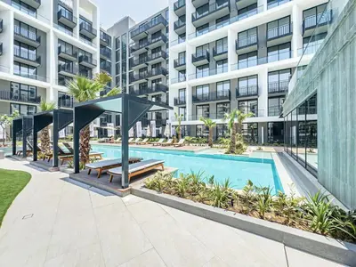 an image of a swimming pool in a building at Modern Studio - Pool, Gym & Padel in Dubai