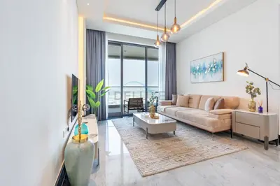 a living room with a couch and a table at Spacious Balcony with Private Jacuzzi and Stunning Views, Easy Public Transport Access, Terraces Marasi Drive, Business Bay by Deluxe Holiday Homes in Dubai