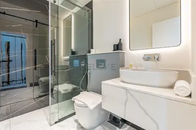 a bathroom with a toilet and a sink and a shower at Spacious Balcony with Private Jacuzzi and Stunning Views, Easy Public Transport Access, Terraces Marasi Drive, Business Bay by Deluxe Holiday Homes in Dubai