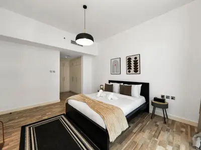 a bedroom with a king sized bed and a table at 4 BHK Duplex - Marina & JBR - Iconic Dubai Skyline in Dubai