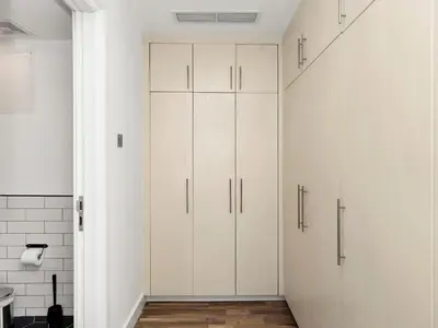 a white closet with white cabinets in a bathroom at 4 BHK Duplex - Marina & JBR - Iconic Dubai Skyline in Dubai