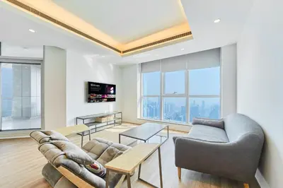 a living room with a couch and a tv at Exclusive Torch Tower Penthouse In Dubai Marina in Dubai