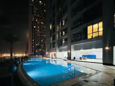 a swimming pool in the middle of a building at night at Exclusive Torch Tower Penthouse In Dubai Marina in Dubai