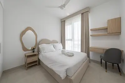 a bedroom with a bed and a desk and a mirror at Luxury Villa 3BR with garden in Dubai
