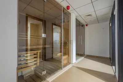 a room with glass walls and a staircase in a building at Iconic Views of the Future Museum, Minutes from Metro & Key Attractions, Sky Gardens, DIFC by Deluxe Holiday Homes in Dubai