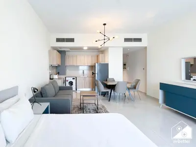 a bedroom with a bed and a living room and a kitchen at Gorgeous Studio with balcony l Business Bay in Dubai