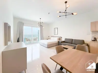 a living room with a couch and a table at Gorgeous Studio with balcony l Business Bay in Dubai