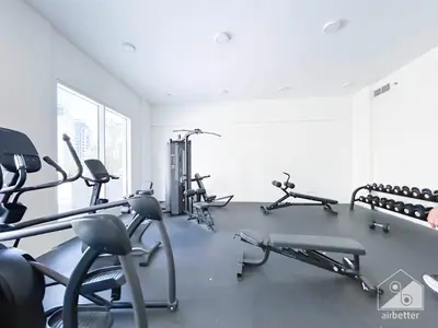 a gym with several treadmills and exercise bikes at Gorgeous Studio with balcony l Business Bay in Dubai