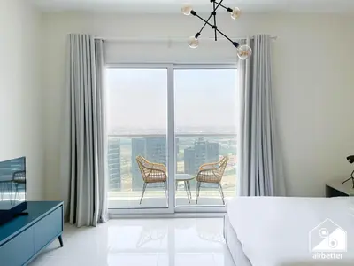 a bedroom with a bed and a table and chairs at Gorgeous Studio with balcony l Business Bay in Dubai