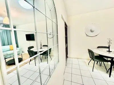 a room with a table and chairs and a dining room at 5 mins walk to Burjuman metro in Dubai