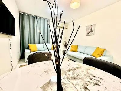 a living room with a table and a couch at 5 mins walk to Burjuman metro in Dubai