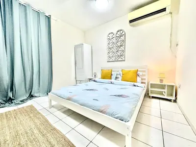 a bedroom with a bed with blue sheets and yellow pillows at 5 mins walk to Burjuman metro in Dubai