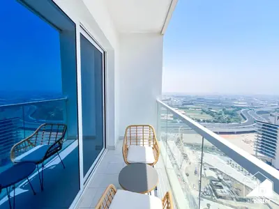 a balcony with chairs and a view of the city at City-View Studio in AG Tower l Pool & Gym Access in Dubai