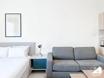a living room with a couch and a bed at City-View Studio in AG Tower l Pool & Gym Access in Dubai
