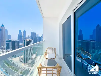 a balcony with a chair and a view of the city at City-View Studio in AG Tower l Pool & Gym Access in Dubai