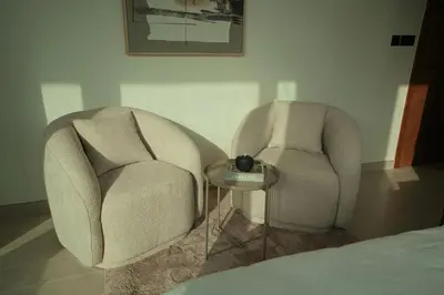 two chairs and a table in a room at Private Jacuzzi 2BR Luxury Unit in Dubai