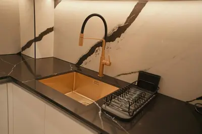 a kitchen counter with a sink and a keyboard at Private Jacuzzi 2BR Luxury Unit in Dubai