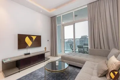 a living room with a couch and a large window at Vogue Business Bay Damac Maison Prive near Burj Khalifa and Dubai Mall, One Bedroom Apartment with Balcony, Canal and City Skyline View, Access to all Amenities in Dubai