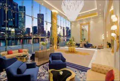 a living room with a view of a city at Vogue Business Bay Damac Maison Prive near Burj Khalifa and Dubai Mall, One Bedroom Apartment with Balcony, Canal and City Skyline View, Access to all Amenities in Dubai