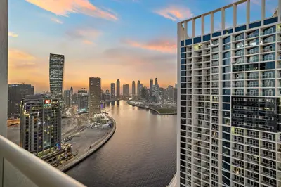 a view of a city with a river and buildings at Vogue Business Bay Damac Maison Prive near Burj Khalifa and Dubai Mall, One Bedroom Apartment with Balcony, Canal and City Skyline View, Access to all Amenities in Dubai