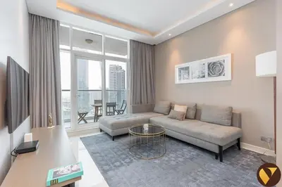 a living room with a couch and a table at Vogue Business Bay Damac Maison Prive near Burj Khalifa and Dubai Mall, One Bedroom Apartment with Balcony, Canal and City Skyline View, Access to all Amenities in Dubai