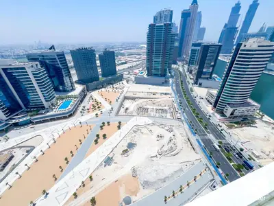 a view of a city with a beach and buildings at Skyline Studio Escape l Balcony , Gym & Pool in Dubai