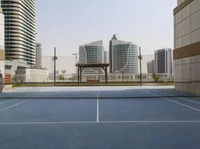 a tennis court in a city with tall buildings at 5 Min to Dubai Mall Lux Stay Tennis Court in Dubai