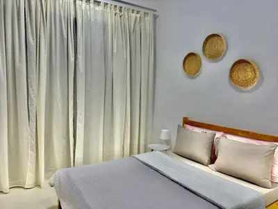 a bedroom with a bed and a large window at 1 min to ADCB metro New home in Dubai