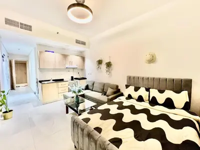 a living room with a bed and a couch at 3 mins walk to ADCB metro in Dubai