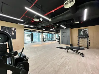 a gym with two treadmills and weights in a room at Modern 1BR with Private Jacuzzi in Business Bay in Dubai