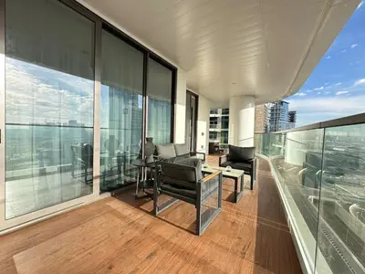 an office with a desk and chairs on a balcony at Modern 1BR with Private Jacuzzi in Business Bay in Dubai