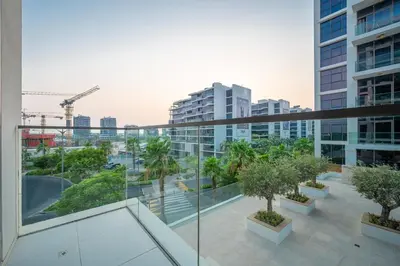 a balcony of a building with trees and buildings at 1BHK Retreat Peaceful & Bright in Dubai