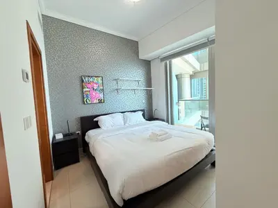 a bedroom with a large bed with a window at Ocean Heights New 2BDR with full Sea & Dubai Eye view in Marina by Simplex Home in Dubai