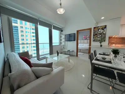 a living room with a couch and a table at Ocean Heights New 2BDR with full Sea & Dubai Eye view in Marina by Simplex Home in Dubai