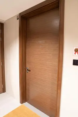 a wooden elevator door with the word cork on it at Lux Sobha Hartland 1 BR with 5 Star Resort Amenities in Dubai