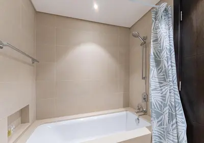 a bathroom with a tub and a shower at Stunning 2 Bedroom at Dubai Creek in Dubai