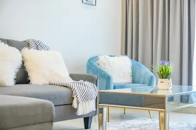 a living room with a couch and two chairs at Luxury 2BR with Burj and Ocean Views in Dubai