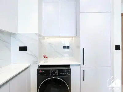 a white kitchen with a black dishwasher at Luxury & Comfort 1B at Binghatti Amber & Balcony in Dubai