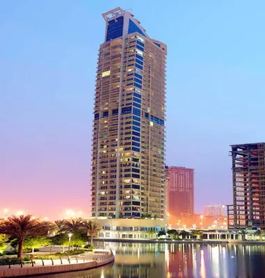 a tall building in a city next to a body of water at HiGuests - Huge Duplex for Creative Inspiration! in Dubai