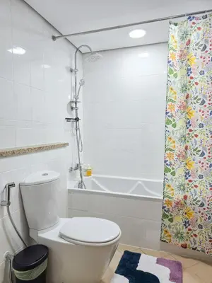 a bathroom with a toilet and a shower curtain at HiGuests - Huge Duplex for Creative Inspiration! in Dubai