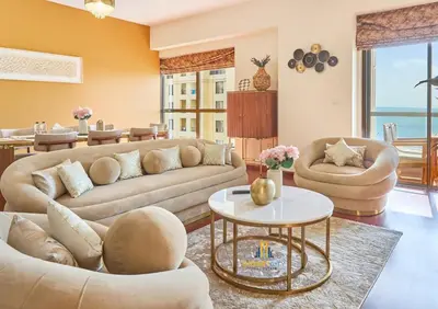 a living room with two couches and a table at Beachfront 2BR, Sea & Ain Dubai View, JBR Walk Hosted by Desert City Stays in Dubai