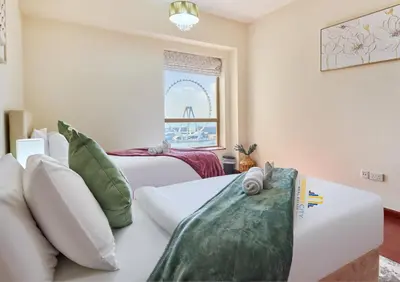 a hotel room with two beds and a window at Beachfront 2BR, Sea & Ain Dubai View, JBR Walk Hosted by Desert City Stays in Dubai