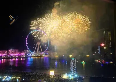 a fireworks display with a ferris wheel in the background at Beachfront 2BR, Sea & Ain Dubai View, JBR Walk Hosted by Desert City Stays in Dubai
