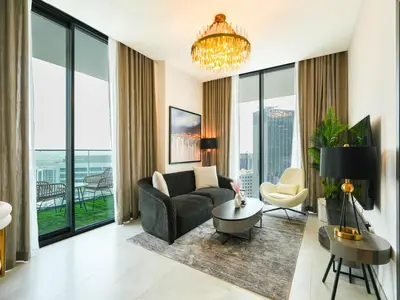 a living room with a couch and a table at Luxury Smart 1BR -High Floor Business Bay Views in Dubai