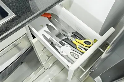 a bunch of scissors sitting on a shelf under a counter at 1BR at Ocean Heights Next to Tram Station in Dubai
