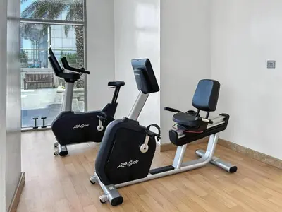 a gym with two exercise bikes in a room at 1BR at Ocean Heights Next to Tram Station in Dubai