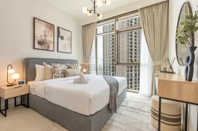 a bedroom with a large bed and large windows at Harbourfront Views 1BR, Near Park and Minutes from Festival City Mall, Creek Palace, Dubai Creek Harbour by Deluxe Holiday Homes in Dubai