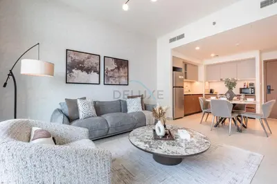 a living room with a couch and a table at Harbourfront Views 1BR, Near Park and Minutes from Festival City Mall, Creek Palace, Dubai Creek Harbour by Deluxe Holiday Homes in Dubai