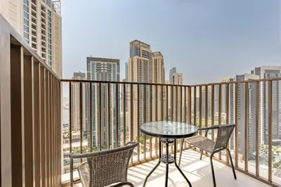 a balcony with a table and chairs and a view of the city at Harbourfront Views 1BR, Near Park and Minutes from Festival City Mall, Creek Palace, Dubai Creek Harbour by Deluxe Holiday Homes in Dubai