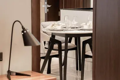 a table with plates and glasses on top of it at Cozy 1BR with Canal Views in Business Bay in Dubai